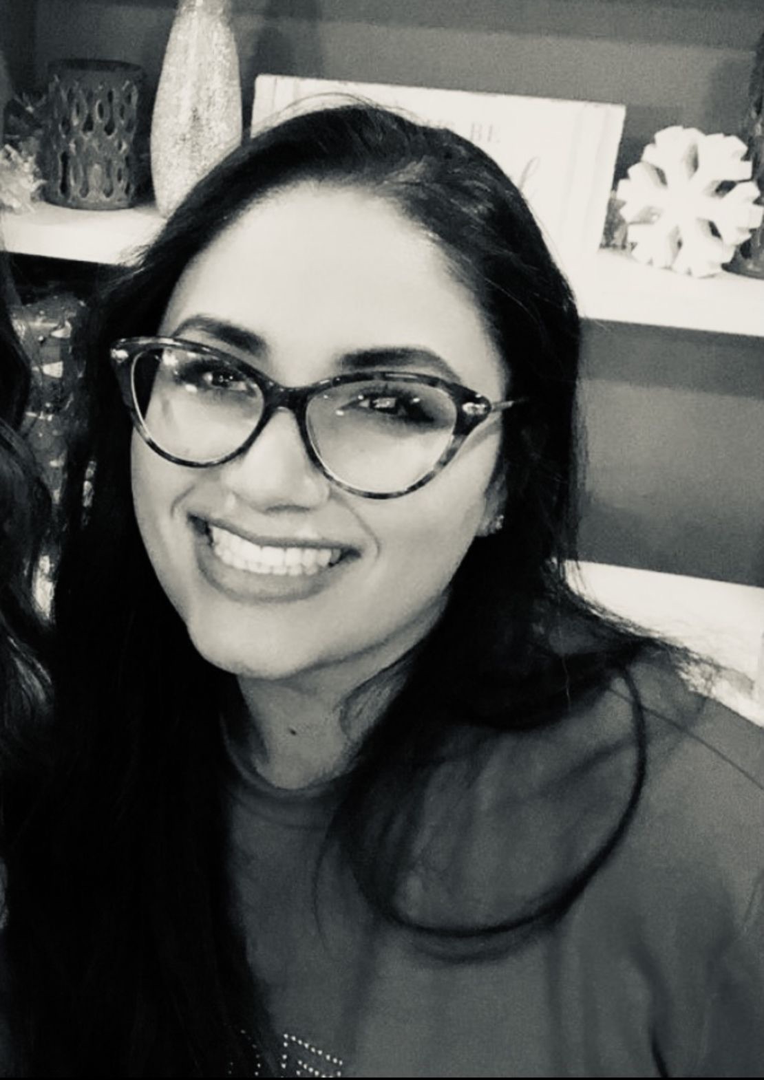 Milena Lozoya, smiling, wearing glasses